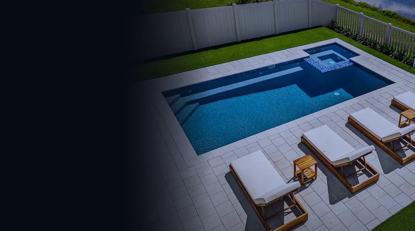 Aerial view of a finished rectangular pool with an attached spa and lounge chairs beside a lake, representing the contractor marketing guide